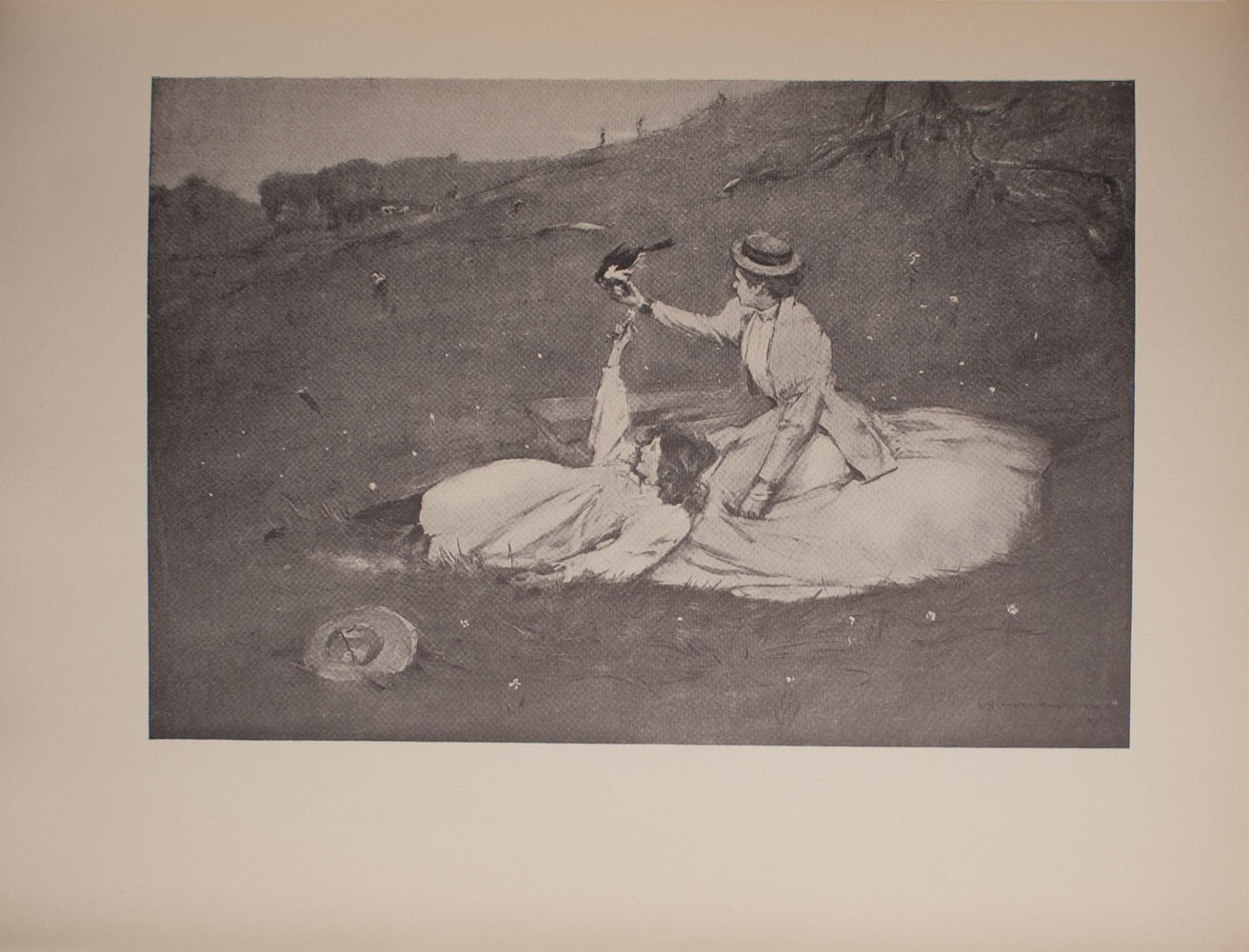 The image is of two women on a hillside One of the women is seated and wears a light coloured skirt with a light coloured jacket Her skirt is spread around her She is wearing a hat and her head is slightly turned away from the viewer Her right arm is extended and a black bird is resting on her fingers The other woman is to the left of the seated woman She is reclined and resting against the seated woman She is wearing a light coloured dress and her hair is down Her right arm is extended towards the black bird She is in profile and smiling Next to the reclining woman further in the foreground is a hat Beyond the two women large tree roots are visible In the background there are more trees and hills Two figures are visible climbing up the hill in the far background There are light coloured flowers around the women The image is horizontally displayed