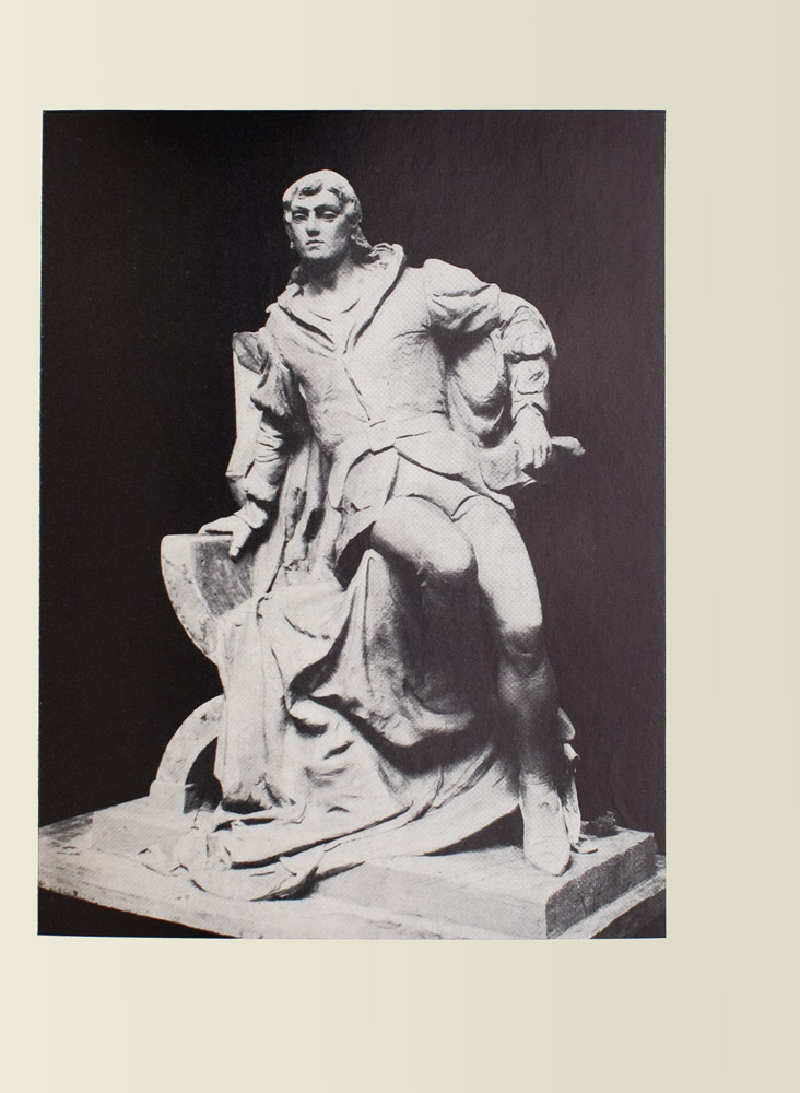 Image is of a statue of a man He is shown in full leaning on a chair covered by a cloak The man is wearing a belted jacket and stockings both are light coloured The jacket has puffed sleeves His right arm is clutching the chair supporting him his left hand is clutching a sheaf of paper His left leg is slightly bent with a flexed foot the right leg is tucked in to him the lower half of it disappearing into his shadow He is wearing pointed shoes His facial expression is stoic with a straight chin and a forward gaze The background is black and undefined The image is vertically displayed